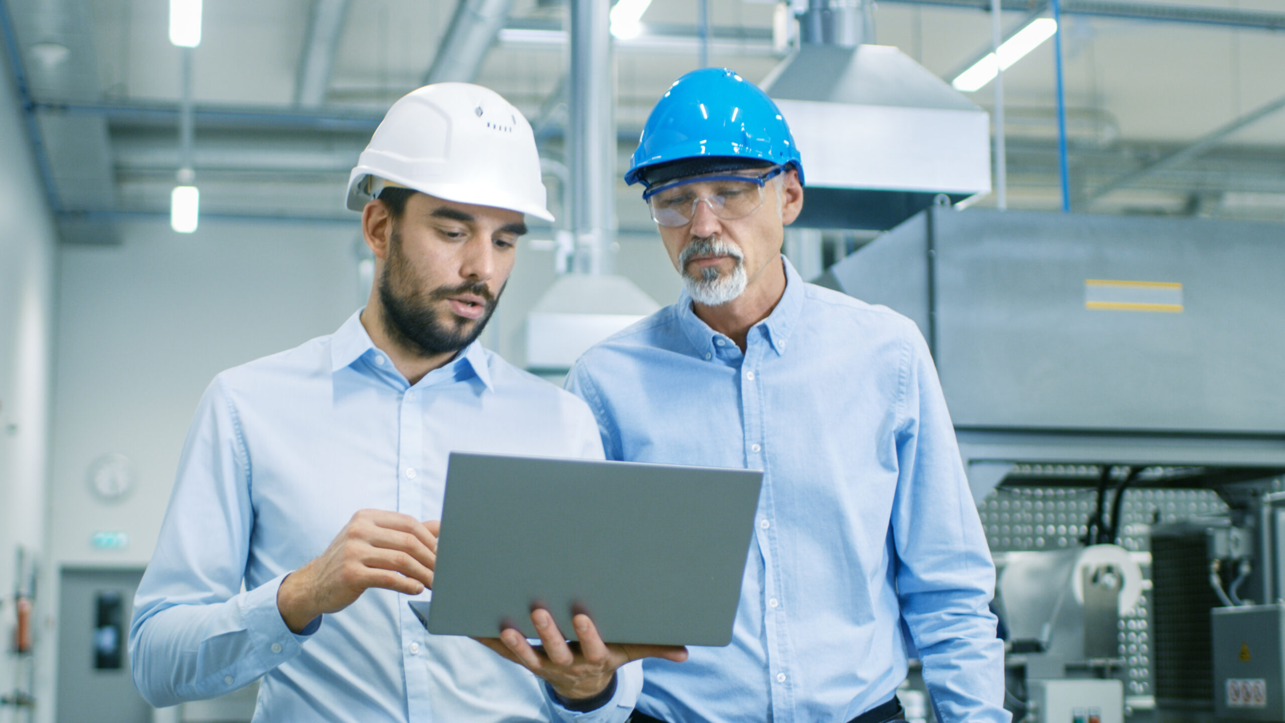 Employees at facility looking at laptop